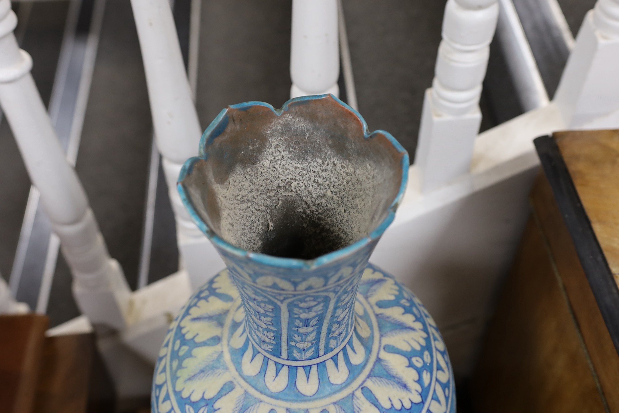 A large Persian fritware floral decorated vase, 67cm tall